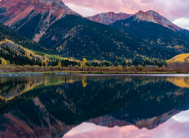 reflection of colorful mountain peaks in a lake in the foreground