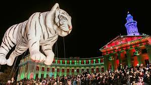 white tiger parade float in front of the Denver City and County Building
