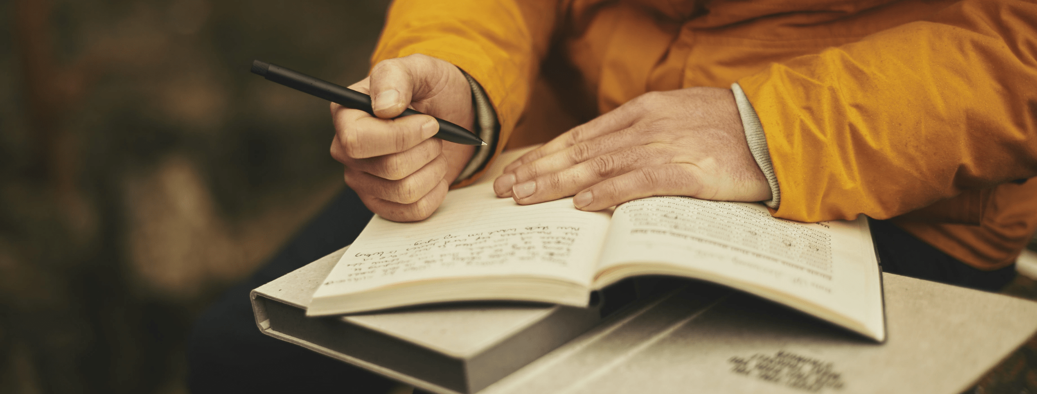 person writing in a diary